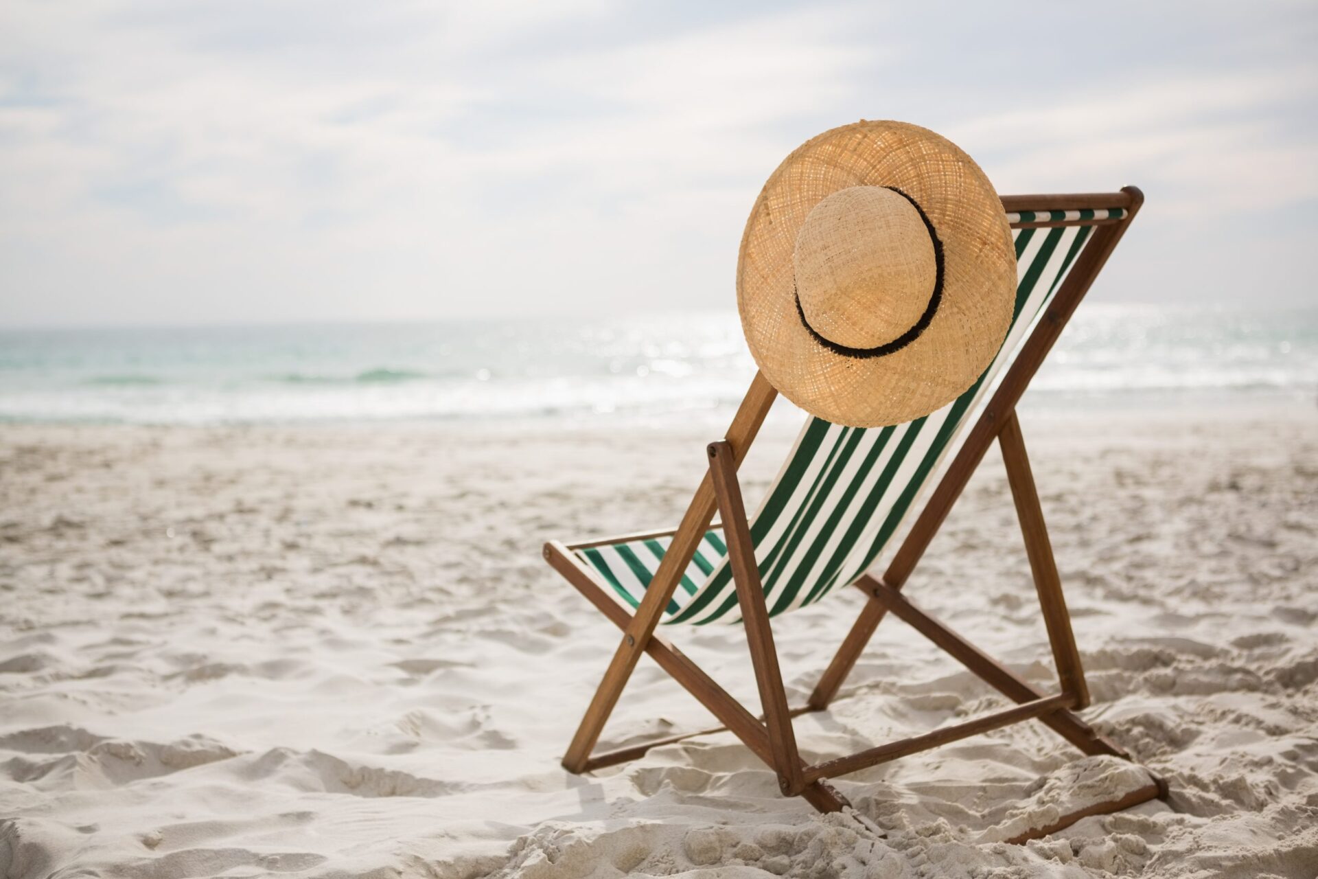 straw hat kept on empty beach chair scaled - Bonnes vacances !